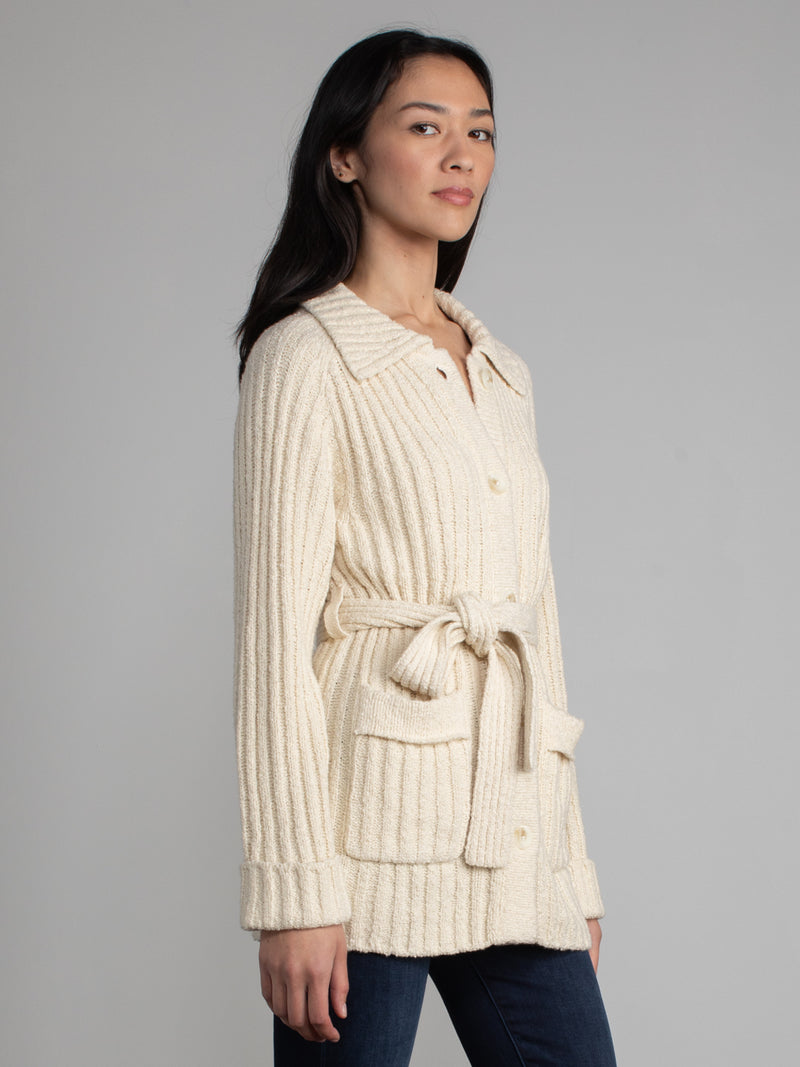 Woman wearing a white fleece button down jacket..
