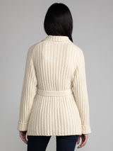 Woman wearing a white fleece button down jacket..