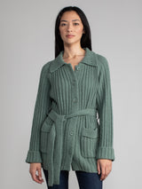 Woman wearing a green fleece button down jacket..