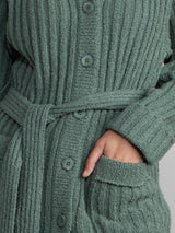 Woman wearing a green fleece button down jacket..