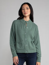Woman wearing a green fleece cropped cardigan.