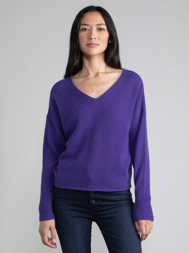 Female model wearing a purple cashmere with v neck.