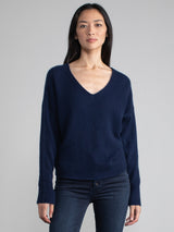 Female model wearing a navy cashmere with v neck.