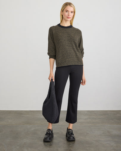 Woman wearing Lola Pullover in black olive with the Cropped Flared Pant in black made by Margaret O'Leary.