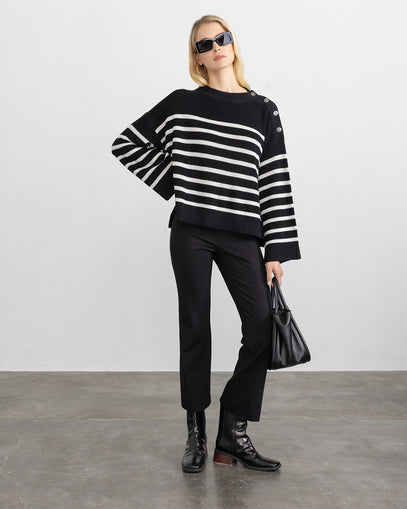 Woman wearing the Bretton Cotton Pullover in black cement and the Cropped Flared Pant in black made by Margaret O'Leary.