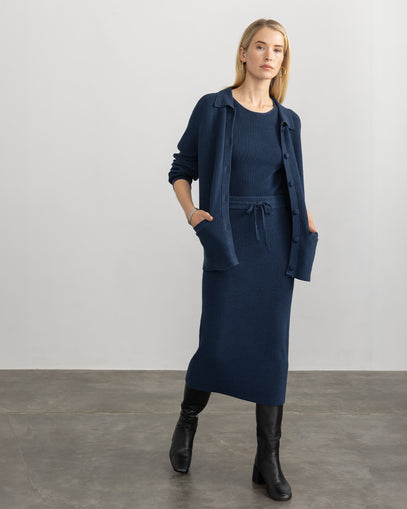 Woman wearing Ribbed Cotton Jacket, Ribbed Cotton Tank, and Ribbed Cotton Skirt in navy made by Margaret O'Leary.