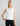 Woman wearing the Boat Neck Tank in white by Margaret O'Leary.