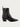 The Halmanera Taby zip boot, a black leather ankle boot with a zipper on a light gray background