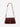 Margaret O'Leary Beverly Medium bag in cherrywood pebbled leather with gold hardware and a crossbody strap.