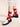 Red socks with white polka dots by Hansel from Basel, worn with black shoes on a beige background