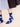 Person wearing blue socks by Hansel from Basel, with white patterns on a beige background