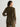 Person wearing an olive green velvet shirt and pants on a white background