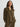 Woman wearing a olive green velvet shirt and pants on a white background