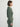 Person wearing the Henley Wedgy Pullover and Joan Waffle Pants,  a green lounge set by Margaret O'Leary, and standing against a white wall.