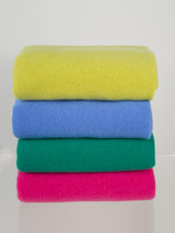 The cashmere travel wrap in sunflower, coast, emerald, and fuchsia by Margaret O'Leary.