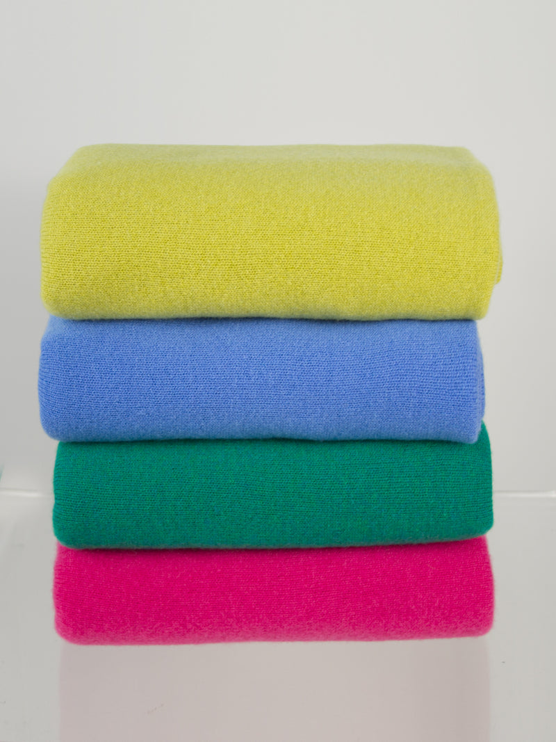 The cashmere travel wrap in sunflower, coast, emerald, and fuchsia by Margaret O'Leary.