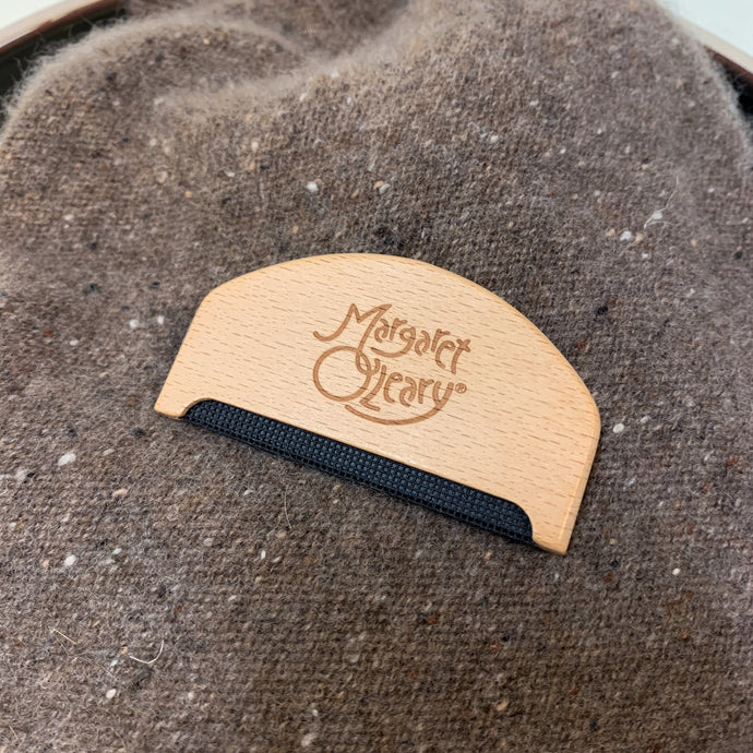 Depiller comb on top of a cashmere sweater by Margaret O'Leary.