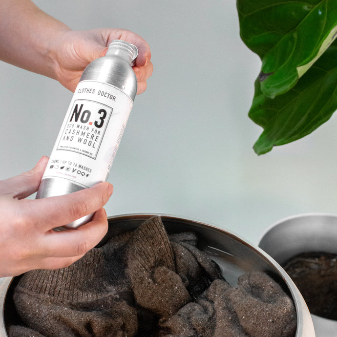 Hand pouring detergent on cashmere sweater by Margaret O'Leary.