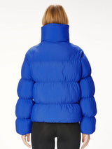 Woman wearing a blue puffer jacket.