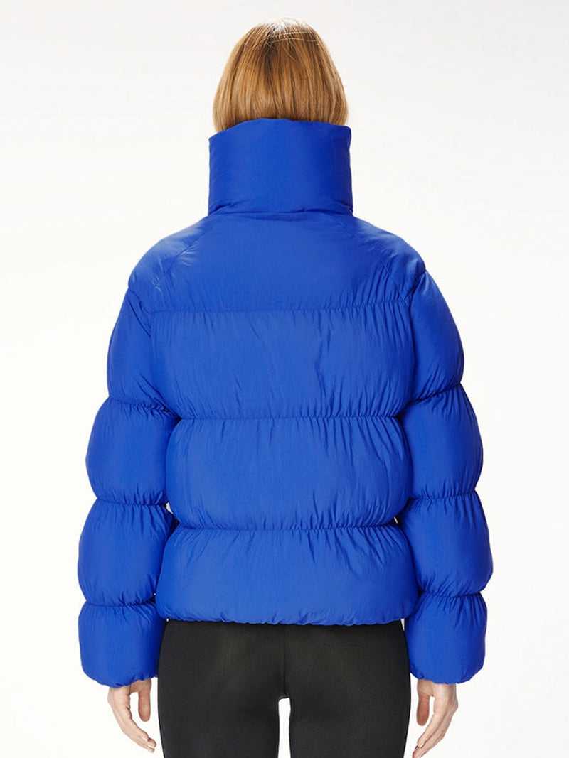 Woman wearing a blue puffer jacket.