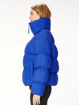 Woman wearing a blue puffer jacket.