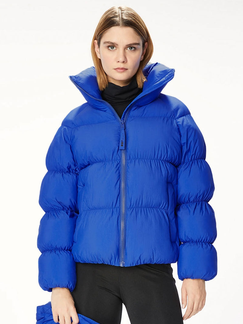 Woman wearing a blue puffer jacket.