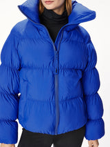 Woman wearing a blue puffer jacket.