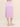 Person wearing a lilac crinkle midi Sabi Skirt by Margaret O'Leary on a beige background