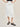 Person wearing a white crinkle midi Sabi Skirt by Margaret O'Leary on a beige background