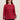 Woman wearing a Nautical Cable Pullover, a red cable knit sweater with striped details on a beige background