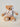 Margaret O’Leary plush teddy bear wearing a beige cashmere button-up V-neck cardigan with a branded ribbon bow.