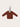 Miniature brown sweater keychain on a beige background