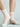 Striped socks with light green accents worn by a person on a light gray background
