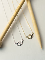 The sterling silver and 14k gold Claddagh necklace by Margaret O'Leary.