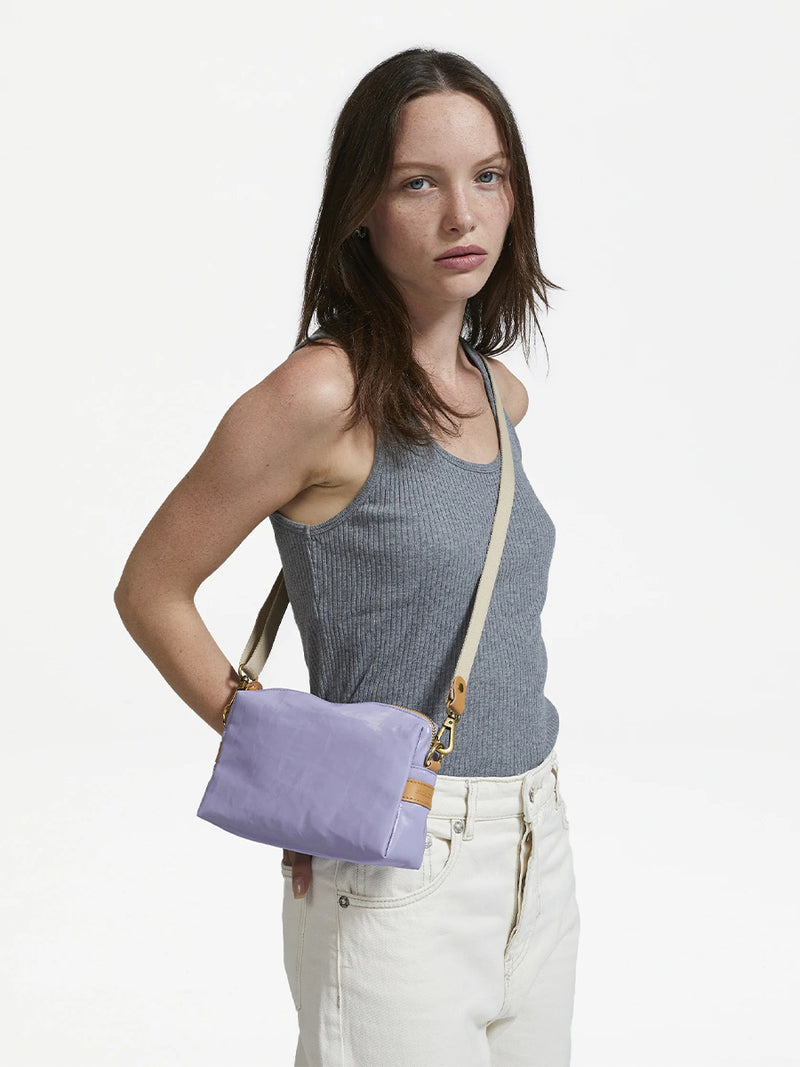 Woman wearing the Mini Linen Shoulder Bag in Lavender by Jack Gomme.