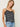 Woman wearing a Lace Silk Cami by Margaret O’Leary, a black silk camisole with lace trim and white line print on a plain background.