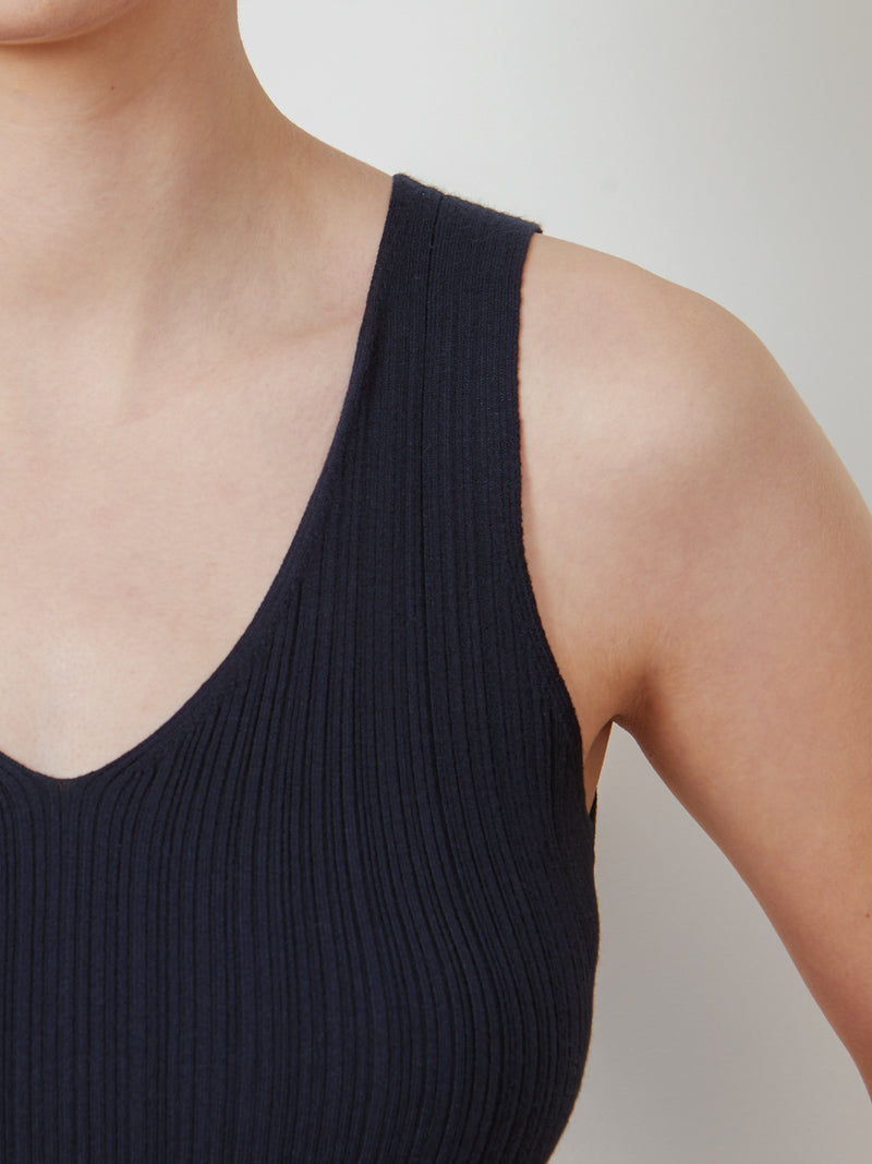 Woman wearing the Selena Rib Tank in Navy by Margaret O'Leary.