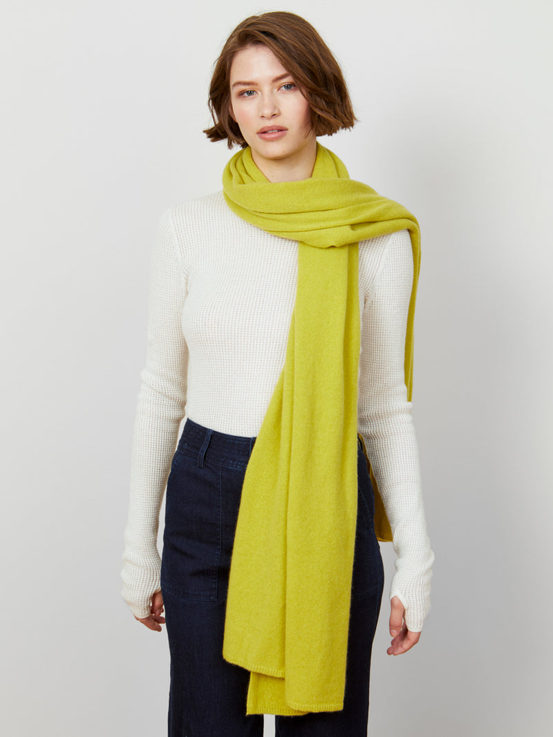 Woman wearing a cashmere travel wrap in sunflower by Margaret O'Leary.