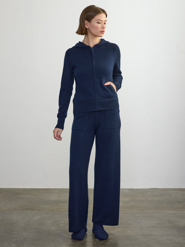 Person wearing the Cashmere Sweats, a blue cashmere sweat pant by Margaret O'Leary paired with a matching cashmere hoodie.