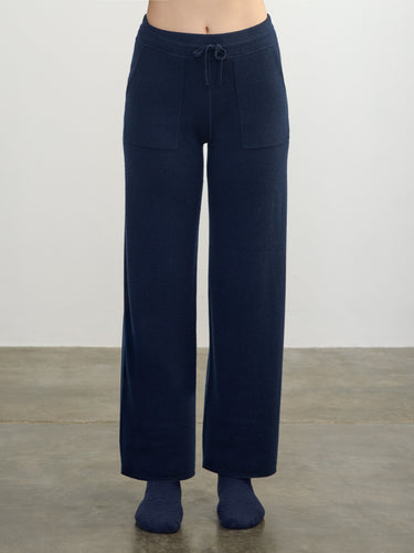 Person wearing the Cashmere Sweats, a blue cashmere sweat pant by Margaret O'Leary.