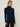 Person wearing the Dimensional Neck, a navy tneck textured sweater by Margaret O'Leary paired with black pants.