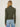 Person wearing the Dimensional Neck, a green tneck textured sweater by Margaret O'Leary paired with blue jeans.
