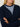 Woman wearing the Fitted Cashmere Hoodie, a navy zip-up hoodie by Margaret O'Leary over a stripe shirt with light blue jeans on a plain background