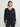 Person wearing the Jacquard Vee, a black and blue patterned sweater by Margaret O'Leary paired with black pants.