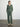 Person wearing the Joan Waffle Pant, a green waffle knit pant by Margaret O'Leary paired with a matching henley top.