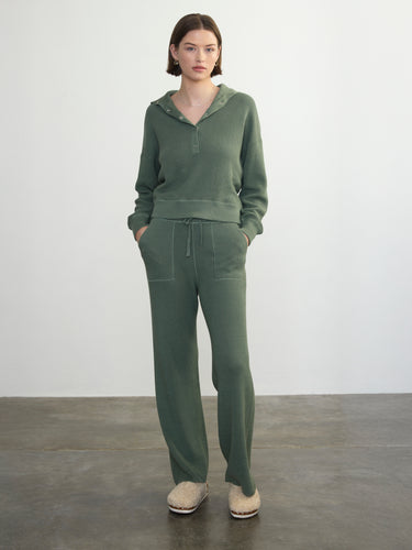 Person wearing the Joan Waffle Pant, a green waffle knit pant by Margaret O'Leary paired with a matching henley top.