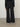 Back view of a person wearing the Parker Pant, a black corduroy plaid pant by Margaret O'Leary.