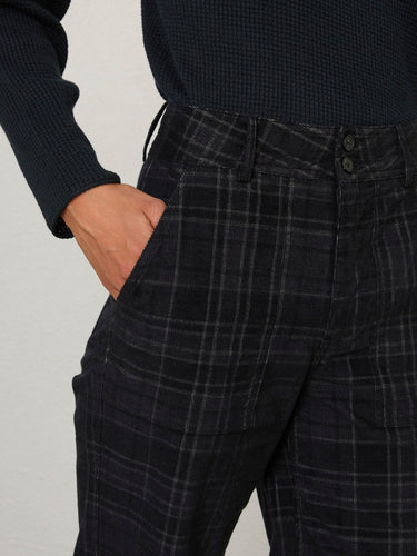 Closeup of a person wearing the Parker Pant, a black corduroy plaid pant by Margaret O'Leary.