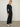 Person wearing the Parker Pant, a black corduroy plaid pant by Margaret O'Leary.