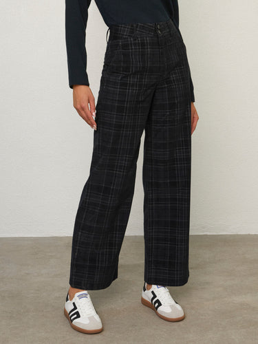 Person wearing the Parker Pant, a black corduroy plaid pant by Margaret O'Leary.